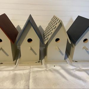 Partially painted birdhouses.